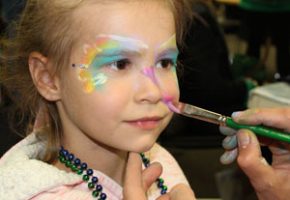 little girl getting face painted - camp magical moments